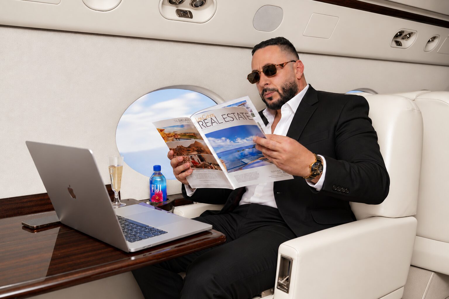 Valentino Sartev reading a Los Cabos real estate publication aboard a private jet