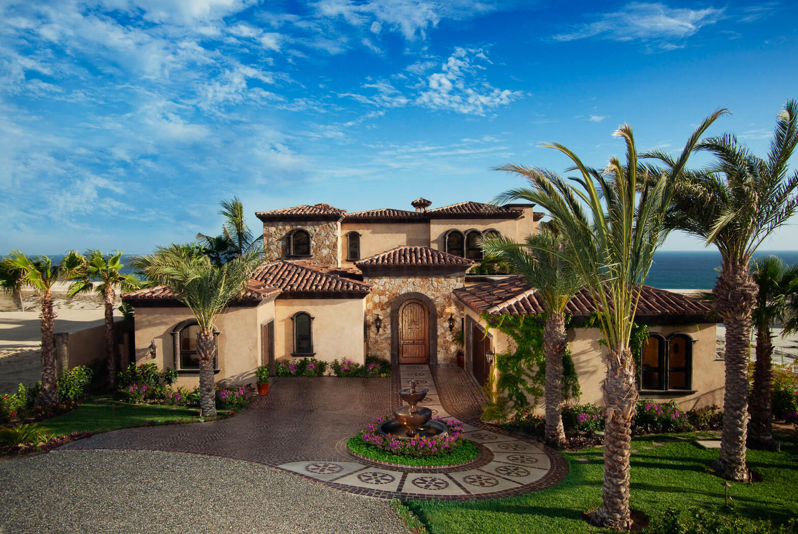 Hacienda-style estate home in Quivira with palms and the Pacific behind