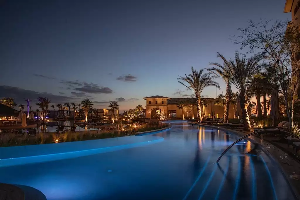 Lazy river and pools of Grand Solmar Pacific Dunes lit at night