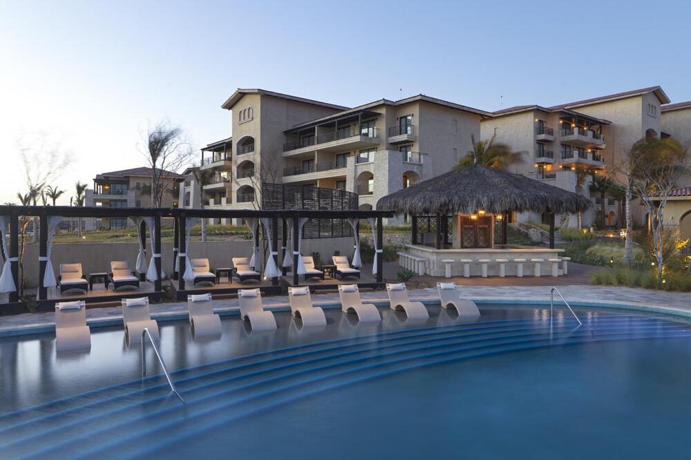 Pool and palapa bar of Grand Solmar at Rancho San Lucas at dusk