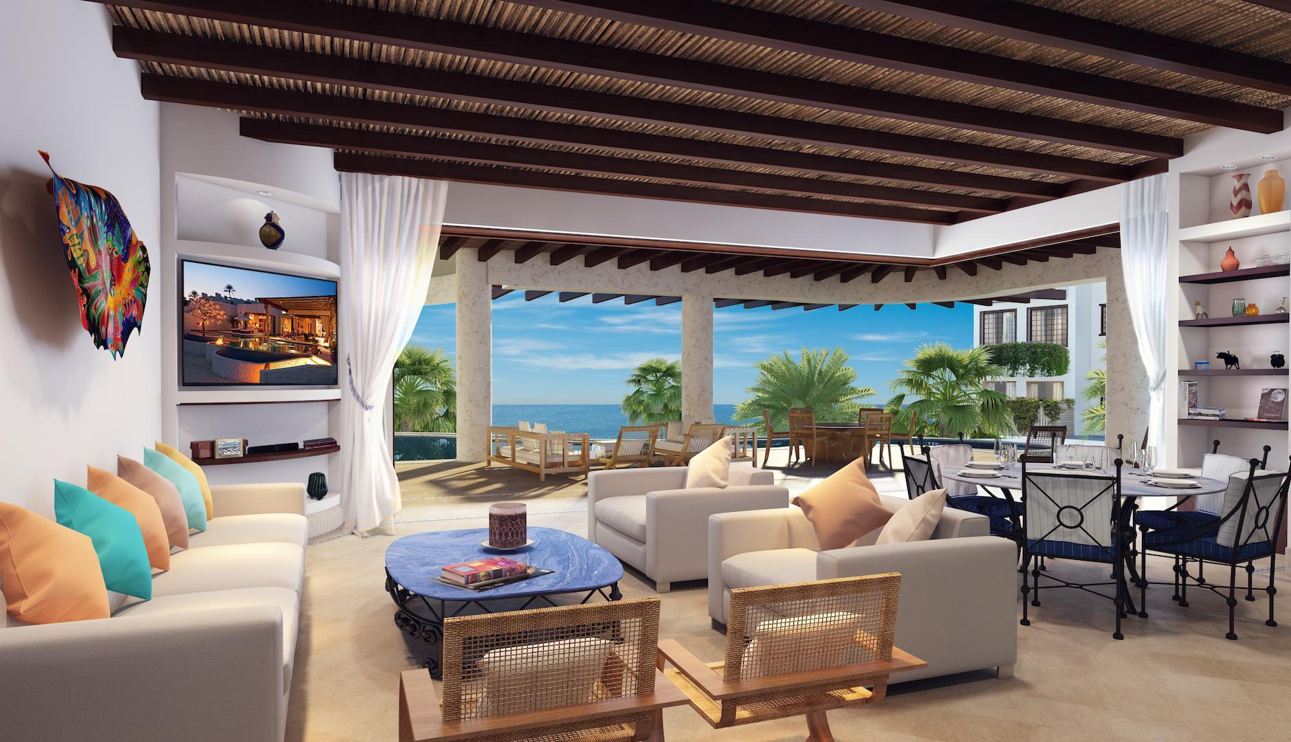 Living room of a Las Ventanas al Paraíso residence opening to a covered terrace and the sea