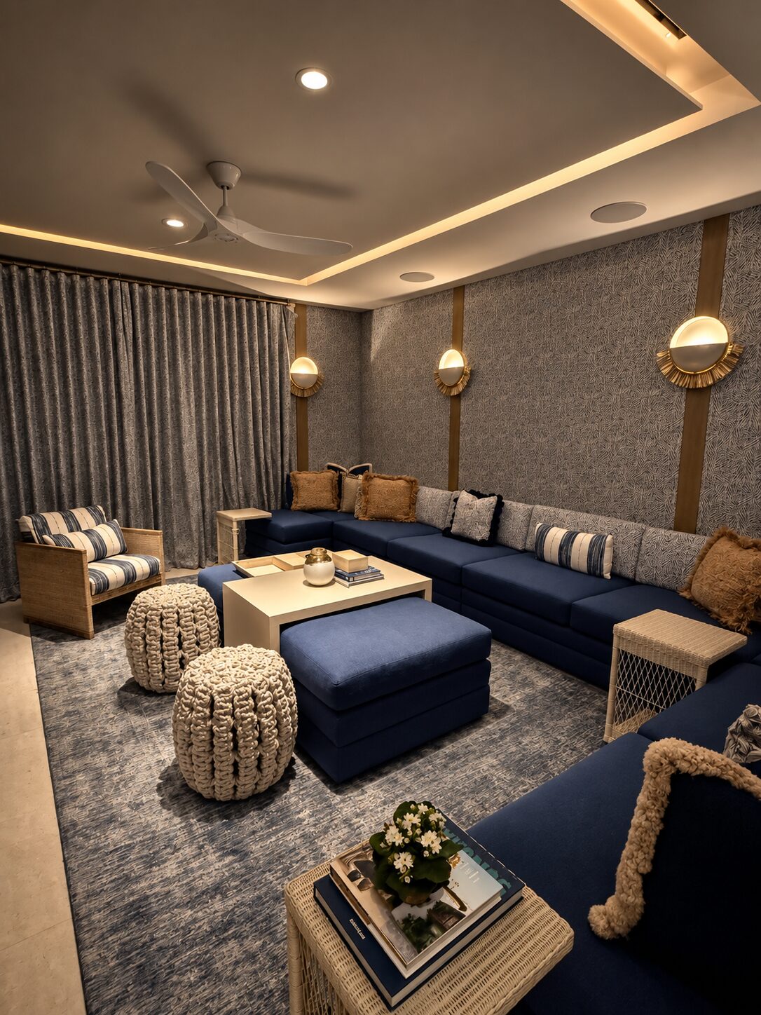 Media room of a Maravilla home in deep indigo with rope poufs and woven wall lamps