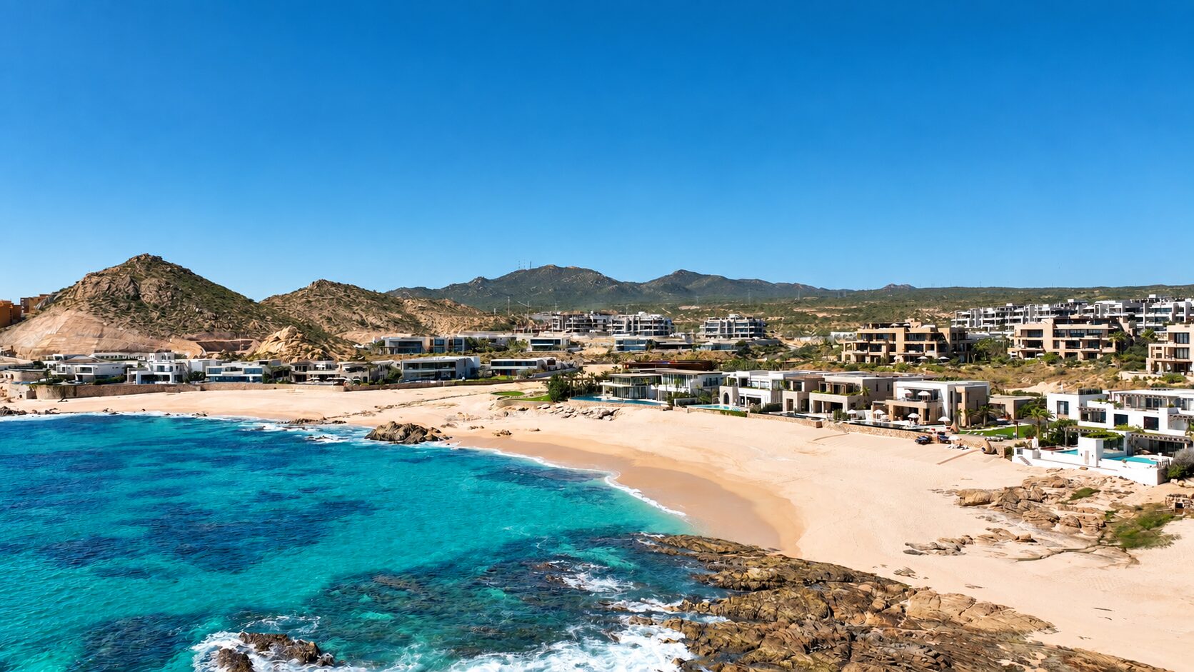 The beach homes of Las Playas at Maravilla lined up along the sand of Santa Maria Bay