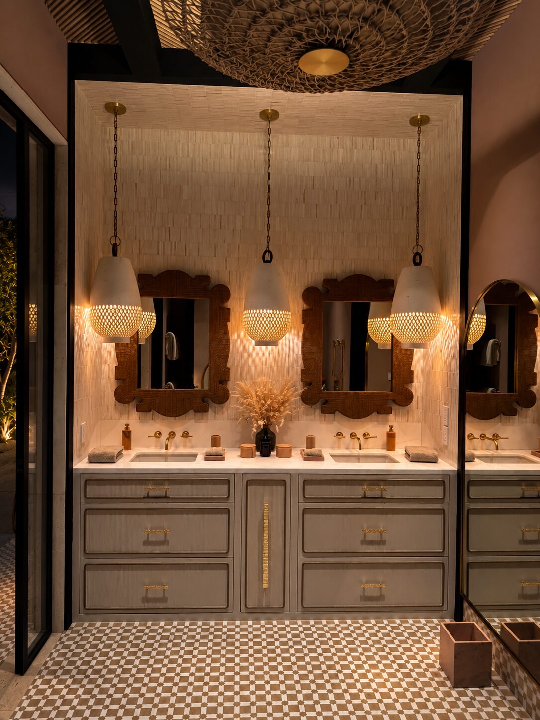 Double vanity in a Maravilla home with carved wood mirrors and hanging ceramic lamps