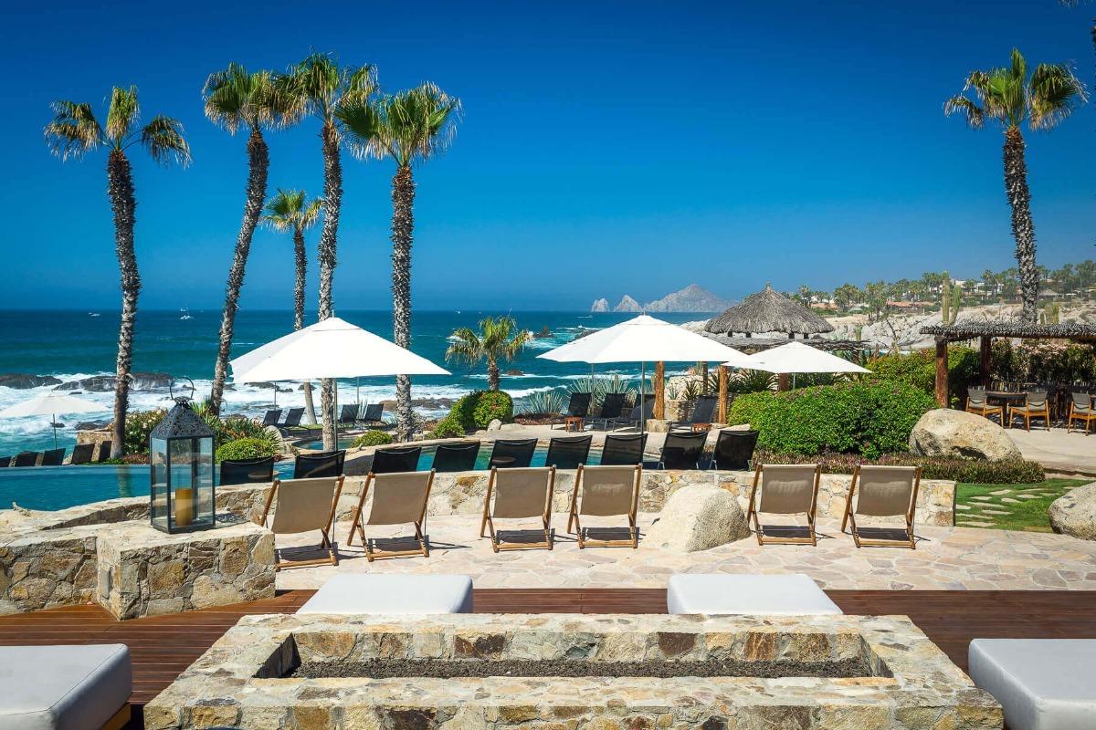 Fire pit and deck chairs at the Punta Ballena Beach Club, with Land’s End on the horizon