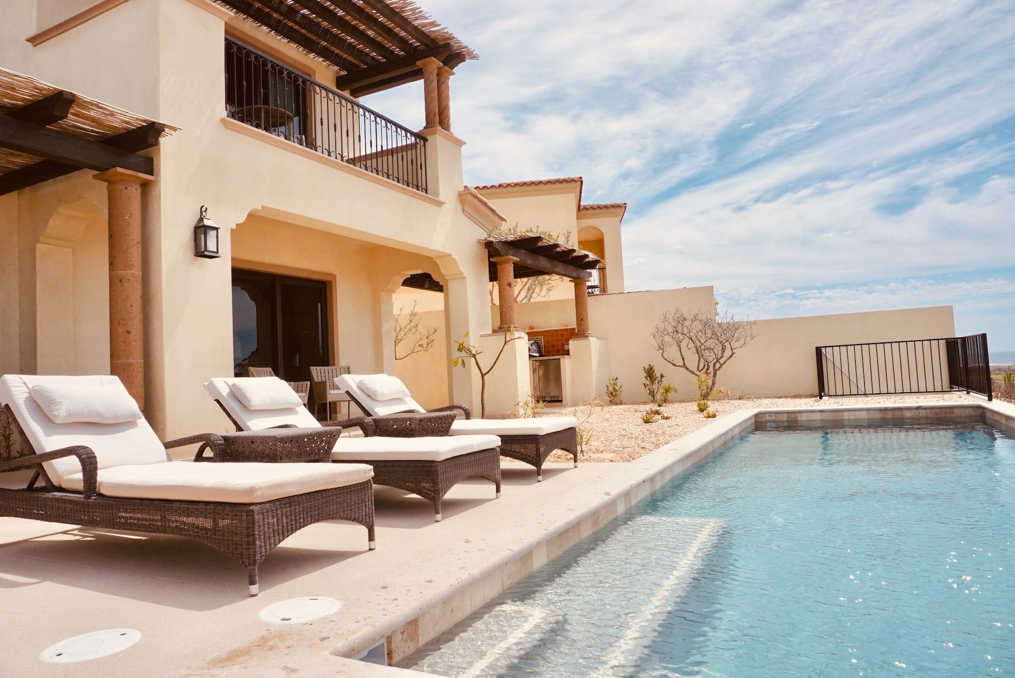 Pool terrace of one of The Villas at Rancho San Lucas, stone columns and pergola above the loungers