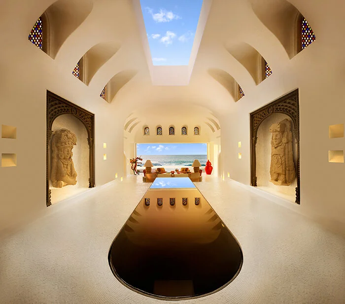 Entrance hall of the Ty Warner Mansion with a reflecting pool leading to the beach
