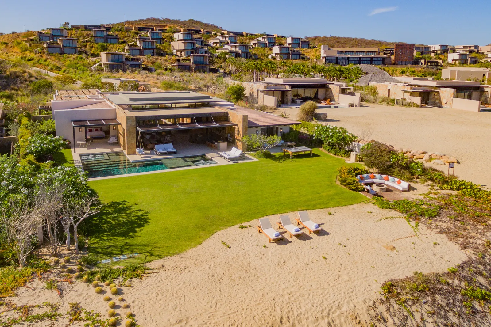 Beachfront villa and lawn opening onto the sand at Puerto Los Cabos